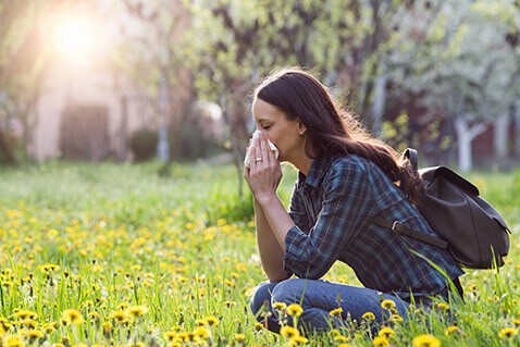 Woman in field with allergies