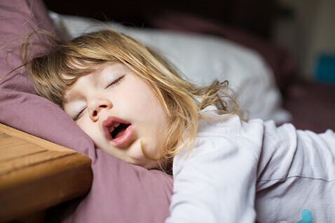 Young girl asleep with mouth open